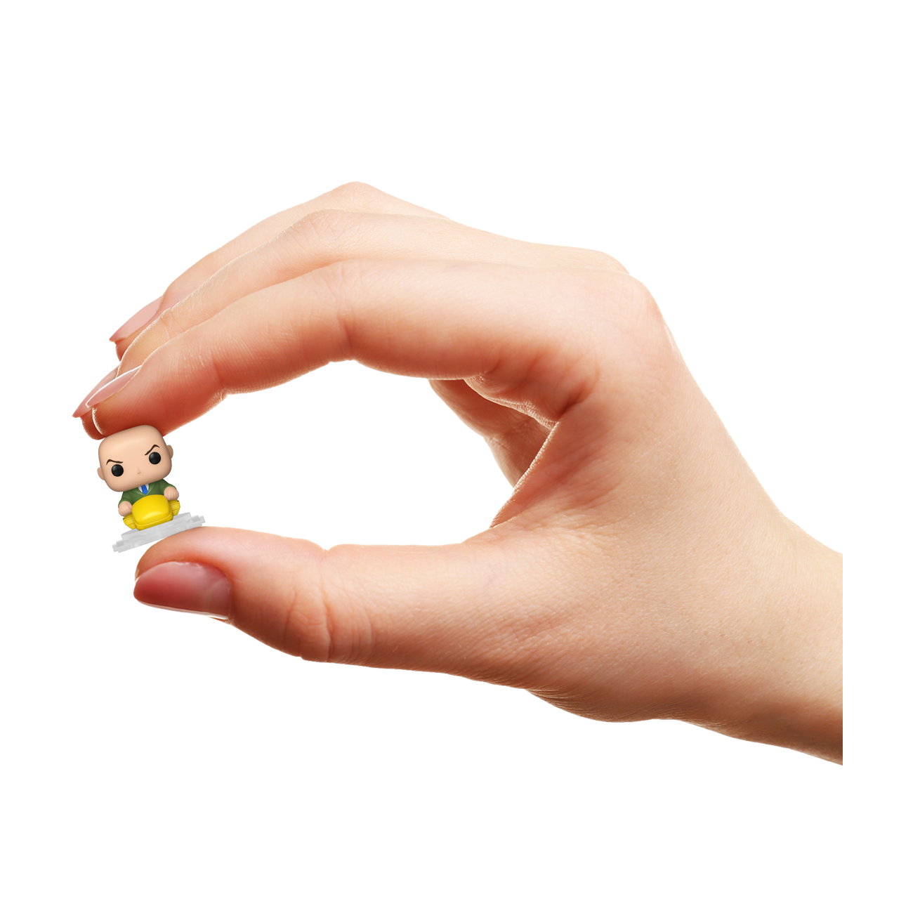 Hand holding a small figurine against a white background