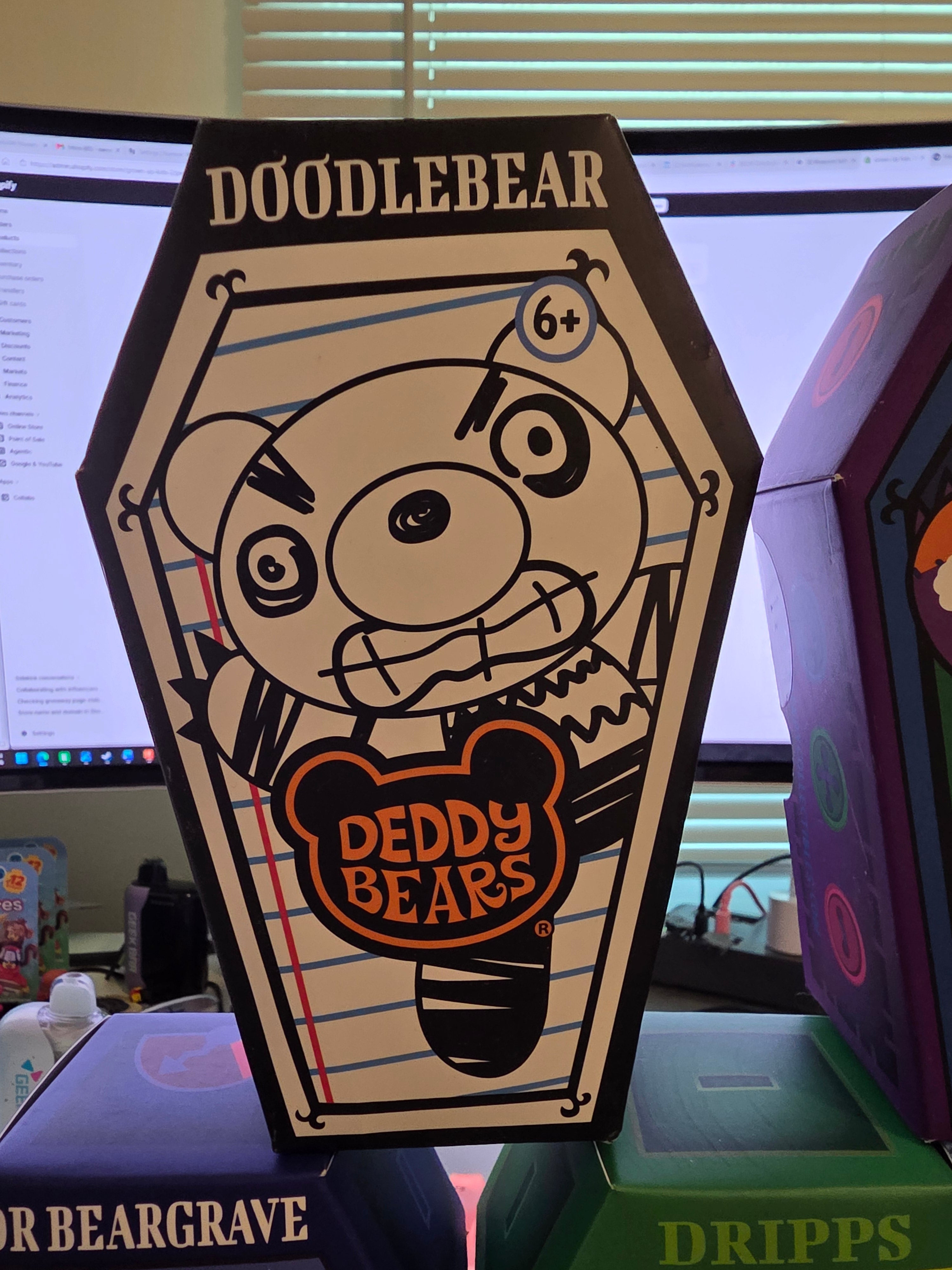 Cartoon bear design on a hexagonal sign with 'Doodlebear' branding.