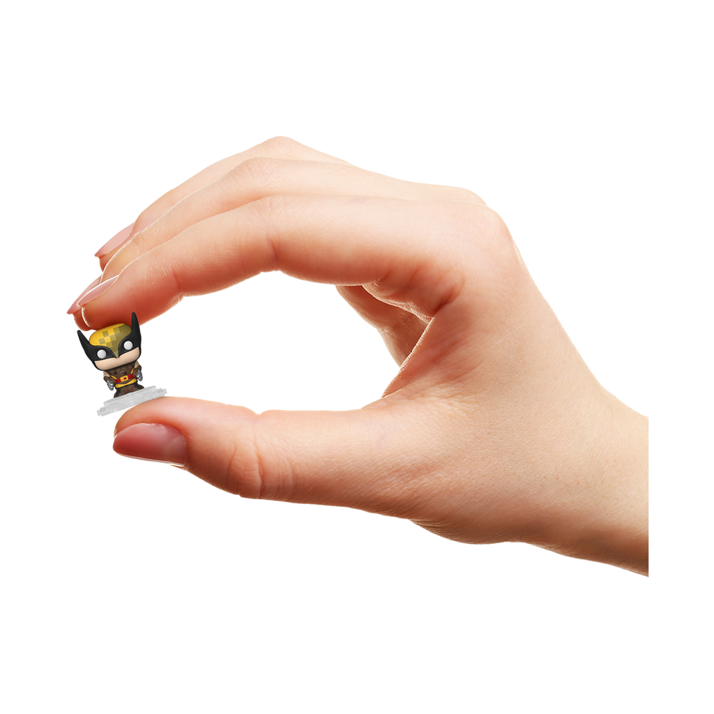 Hand holding a small figurine against a white background