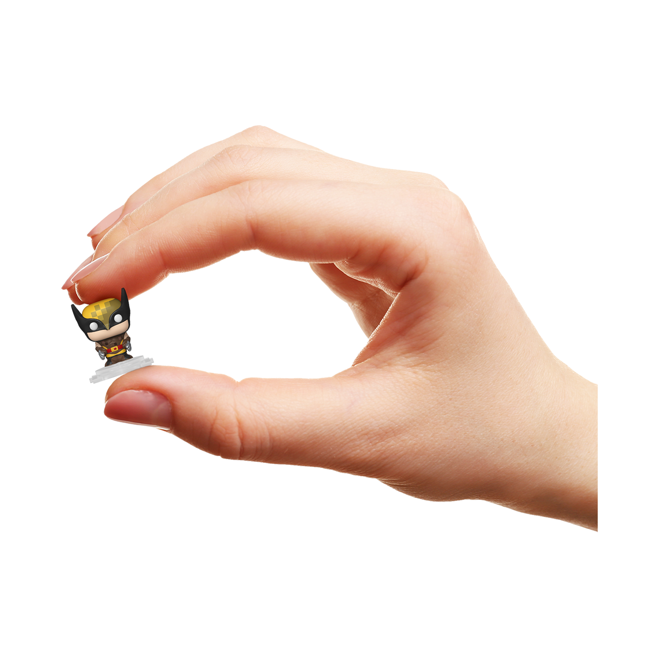 Hand holding a small figurine against a white background